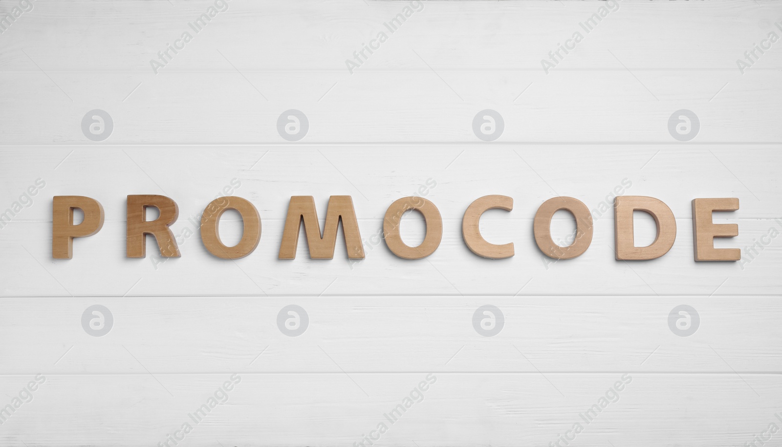 Photo of Word Promocode made of letters on white wooden background, flat lay