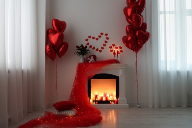 Stylish room with fireplace and Valentine's day decor. Interior design