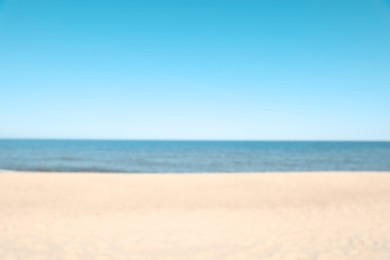 Blurred view of sandy beach near sea