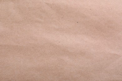 Photo of Texture of kraft paper bag as background, closeup