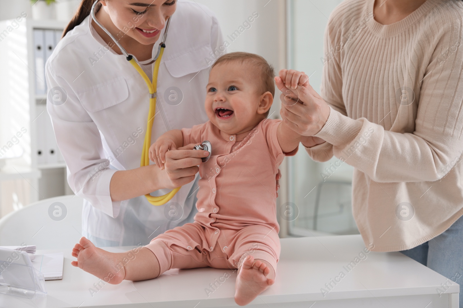 Photo of Mother with her cute baby visiting pediatrician in clinic