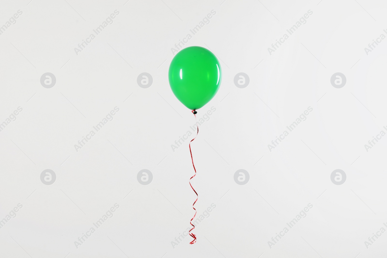 Photo of Bright balloon on light background. Celebration time