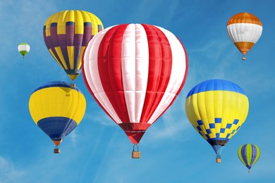 Image of Many bright hot air balloons flying in sky