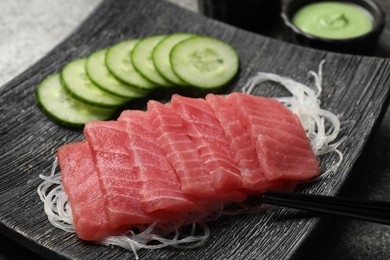 Photo of Tasty sashimi (pieces of fresh raw tuna) and glass noodles on plate, closeup