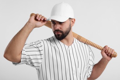 Photo of Man in stylish baseball cap holding bat on white background