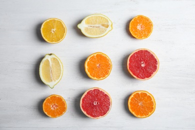 Photo of Different citrus fruits on wooden background, flat lay