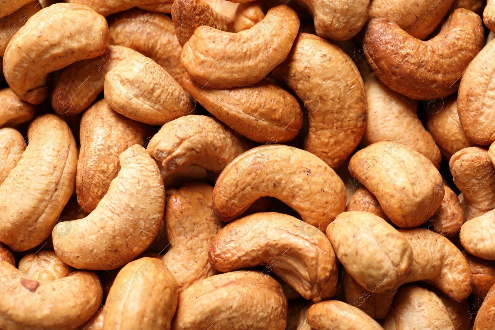 Photo of Tasty cashew nuts as background, top view