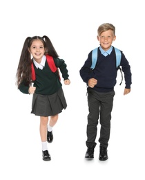 Little children in stylish school uniform on white background