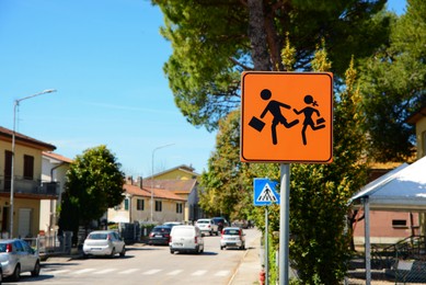 Children Crossing road sign on city street, space for text