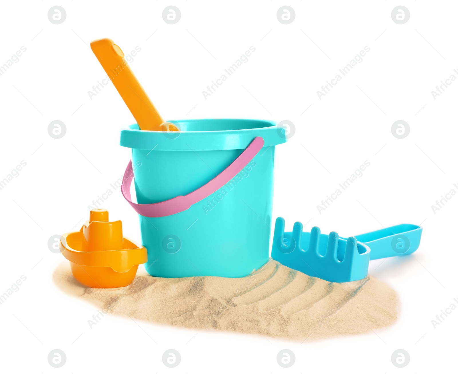 Photo of Plastic beach toys on pile of sand against white background