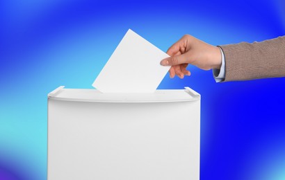 Woman putting her vote into ballot box on color background, closeup