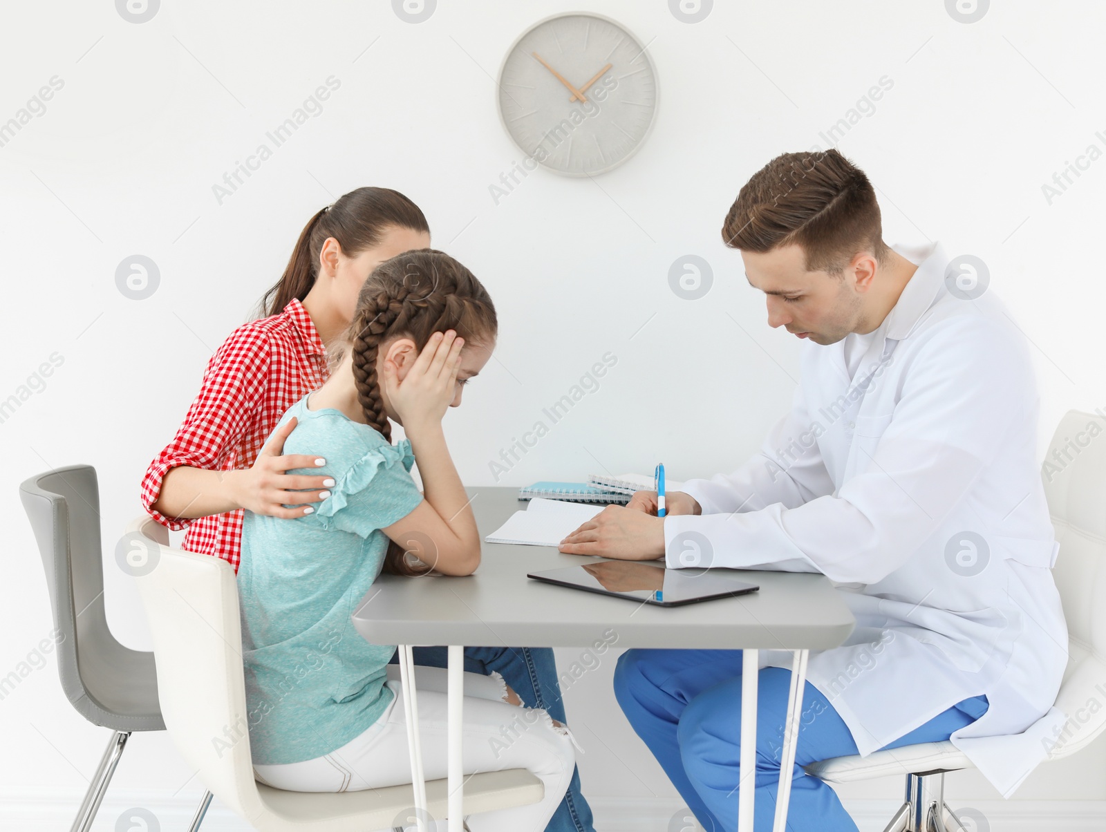 Photo of Young woman with her daughter having appointment at child psychologist office