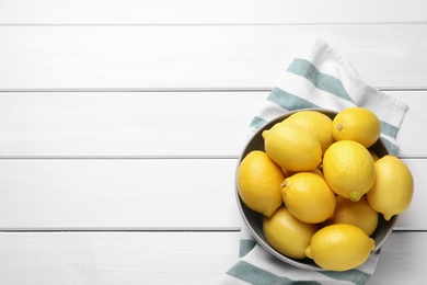 Photo of Many fresh ripe lemons on white wooden table, flat lay. Space for text