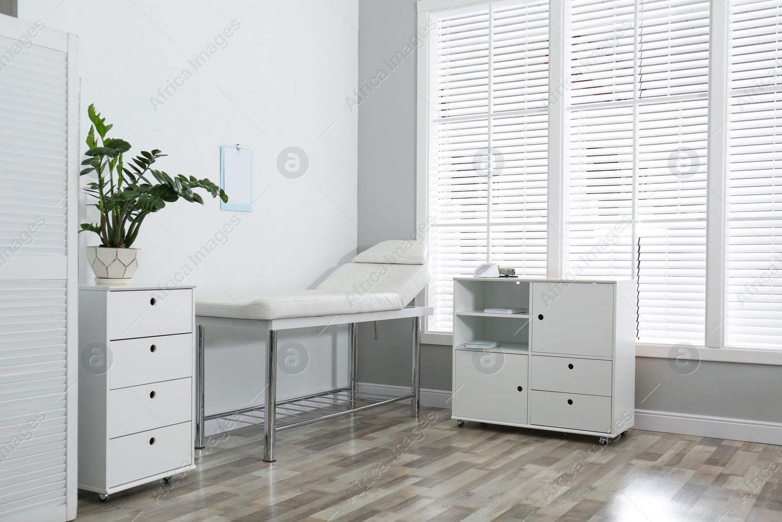 Photo of Modern medical office interior with examination table