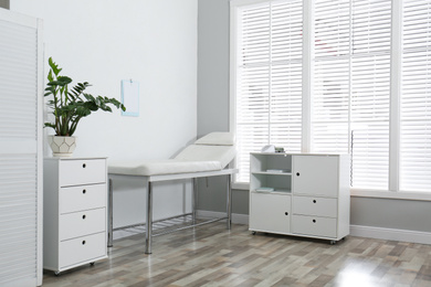 Modern medical office interior with examination table