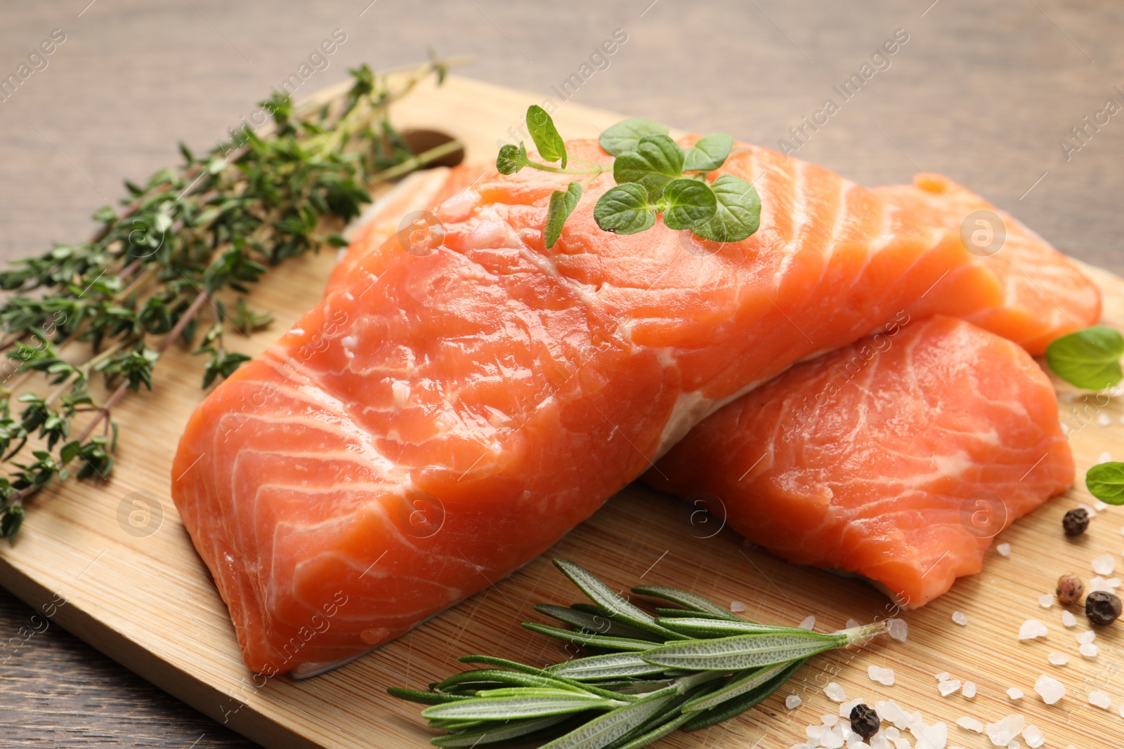 Photo of Fresh raw salmon and ingredients for marinade on wooden table, closeup