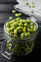 Jar of edamame beans on black wooden table