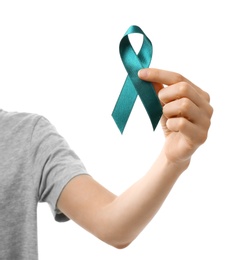 Photo of Woman holding teal awareness ribbon against white background, closeup