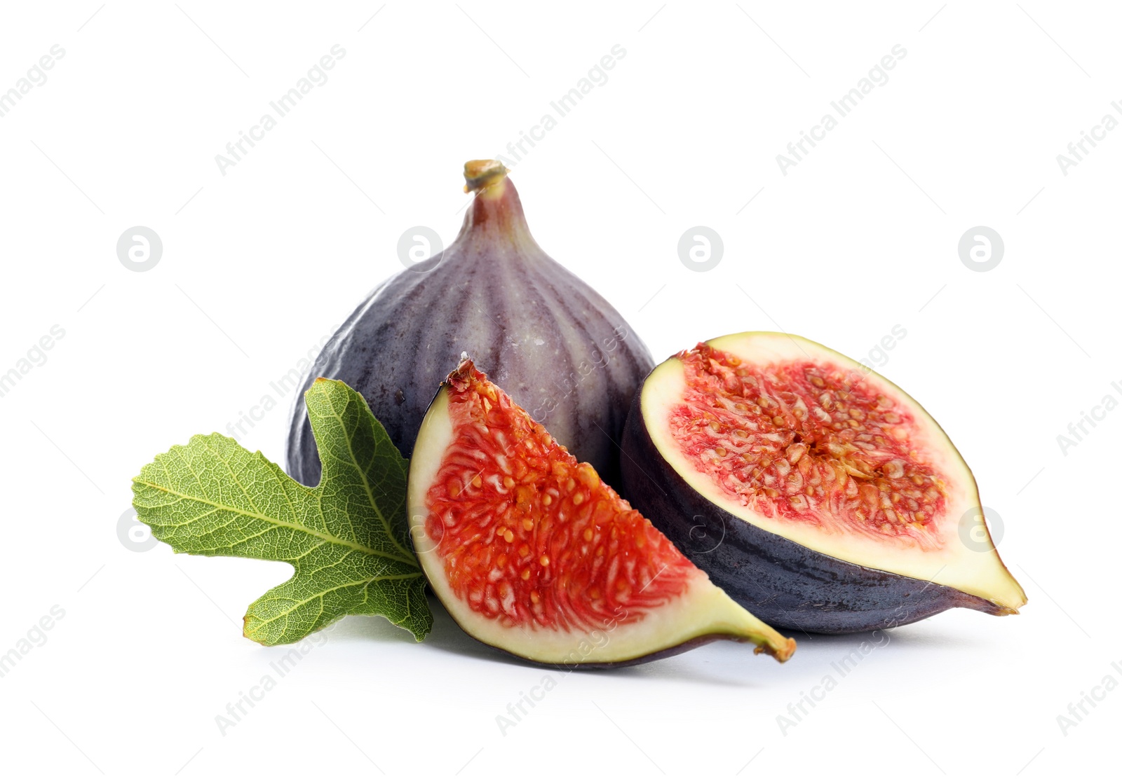 Photo of Whole and cut purple figs on white background