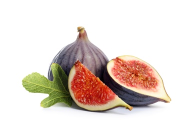 Whole and cut purple figs on white background