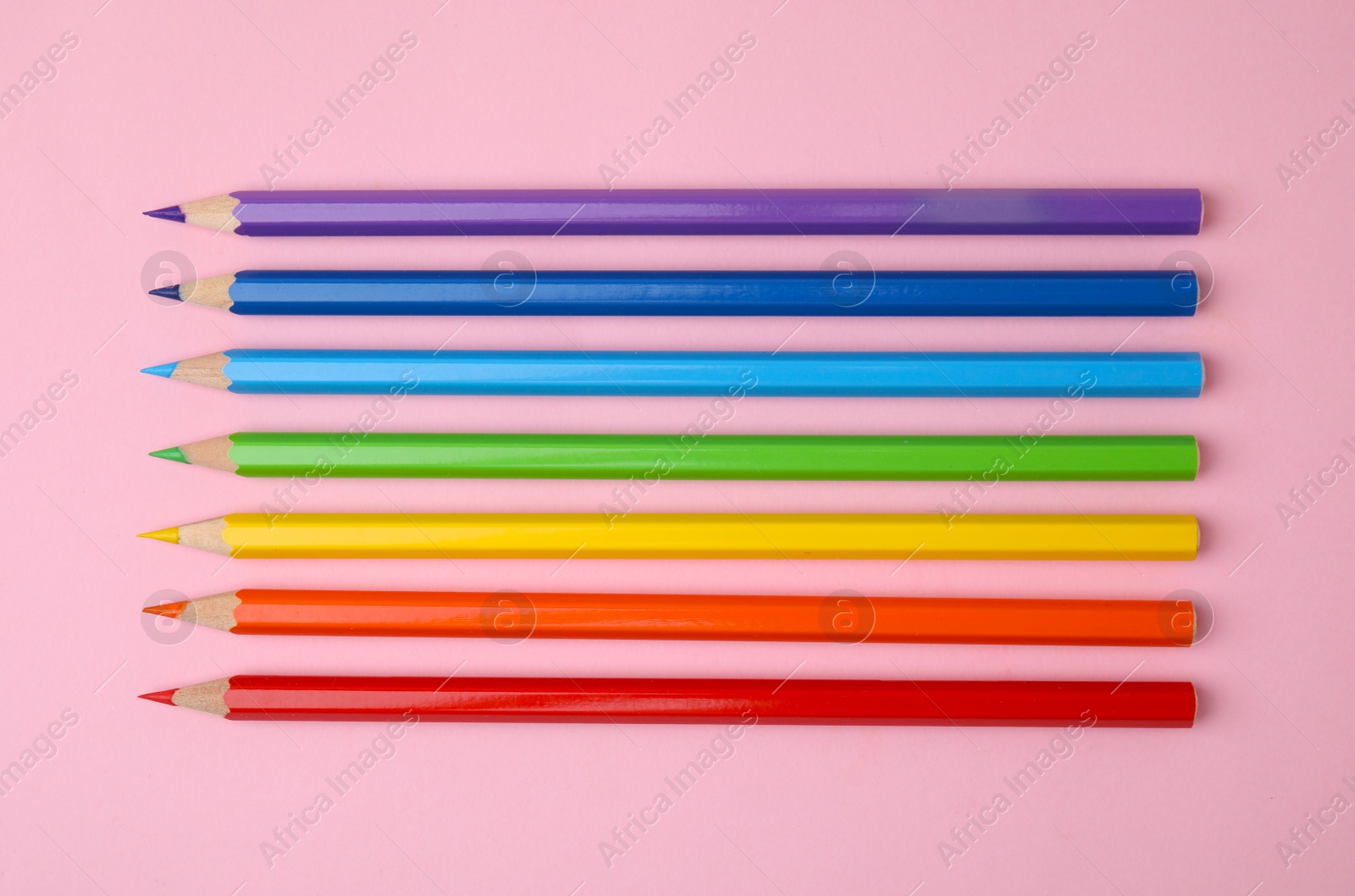 Photo of Colorful wooden pencils on pink background, flat lay