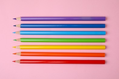 Photo of Colorful wooden pencils on pink background, flat lay