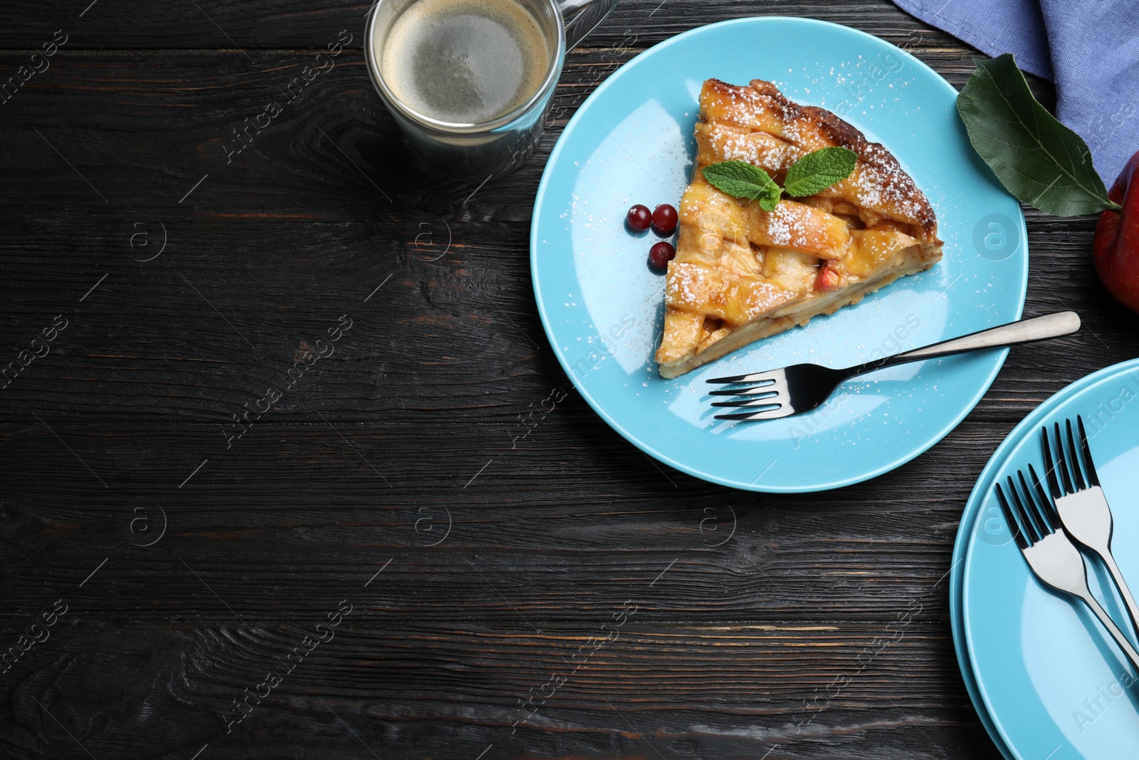 Photo of Slice of traditional apple pie on black wooden table, flat lay. Space for text