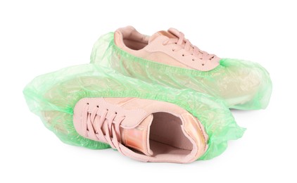 Sneakers in green shoe covers isolated on white