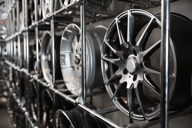 Alloy wheels on racks in automobile service center