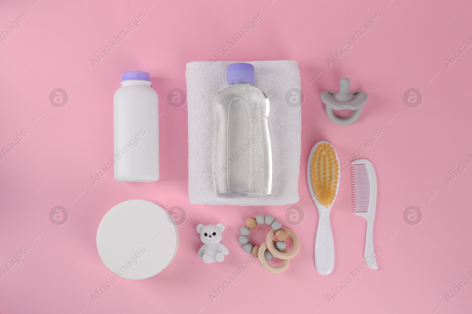 Photo of Flat lay composition with baby care products and accessories on pink background