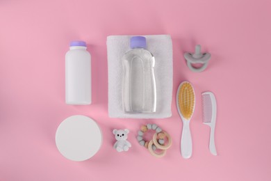 Flat lay composition with baby care products and accessories on pink background