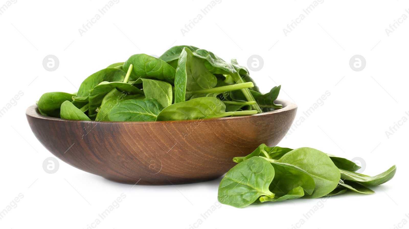 Photo of Bowl and spinach leaves isolated on white