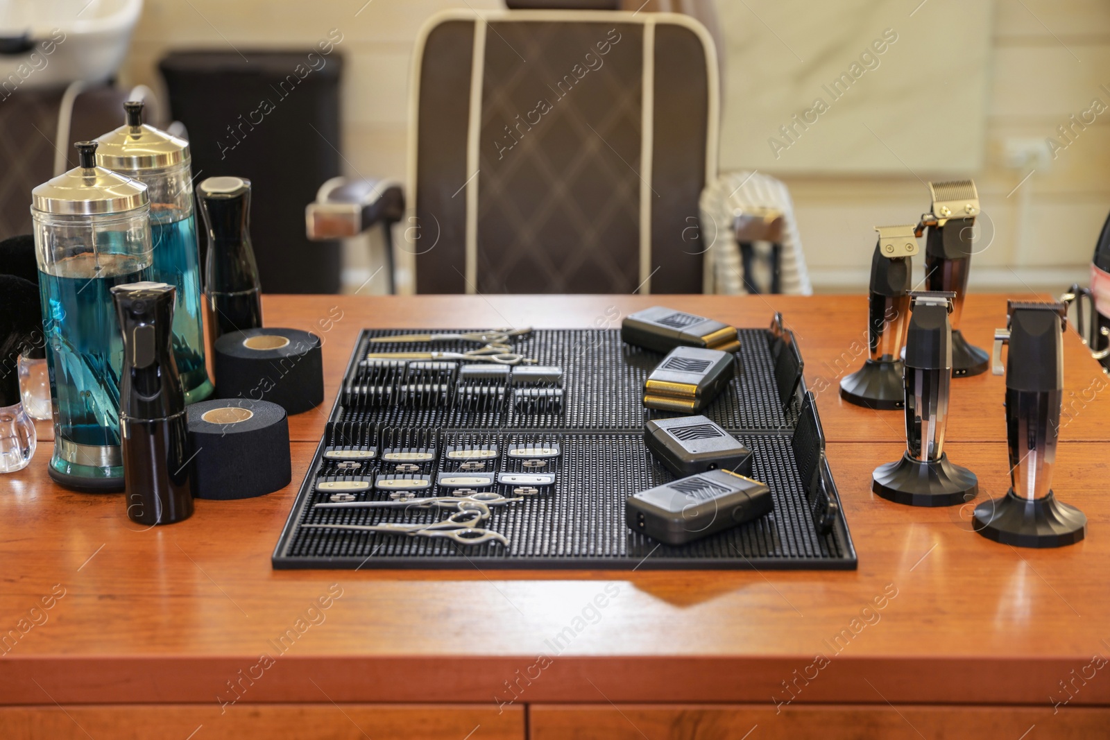 Photo of Stylish hairdresser's workplace with professional tools and cosmetic products in barbershop