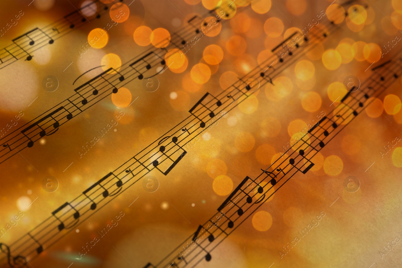 Image of Christmas and New Year music. Music sheet, closeup. Bokeh effect