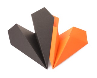 Photo of Handmade black and orange paper planes isolated on white
