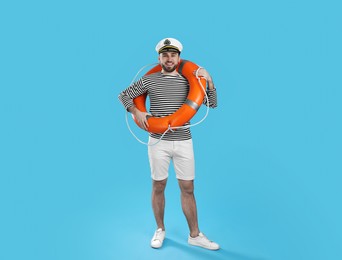 Sailor with ring buoy on light blue background