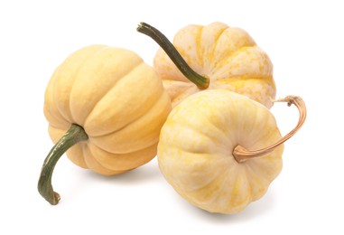 Photo of Three fresh yellow pumpkins isolated on white