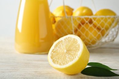 Photo of Fresh ripe lemon on wooden table, closeup
