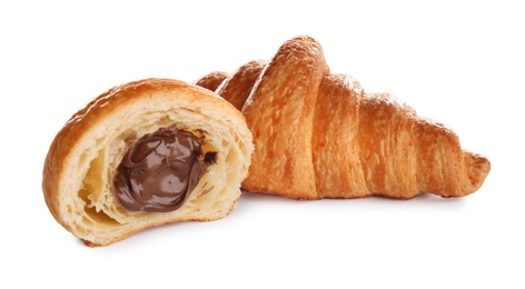 Photo of Fresh croissants with chocolate stuffing on white background. French pastry