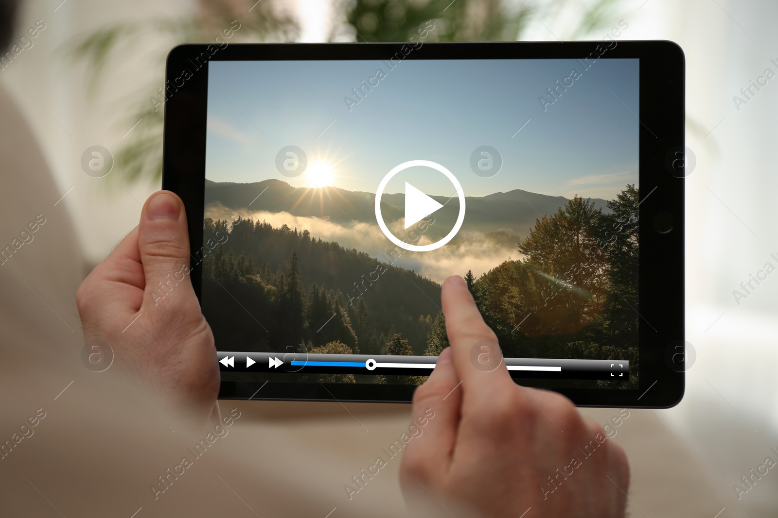 Image of Man watching video on tablet at home, closeup