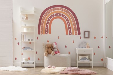 Child's room interior with rainbow painting on wall