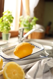 Photo of Fresh ripe lemons on countertop in kitchen, closeup