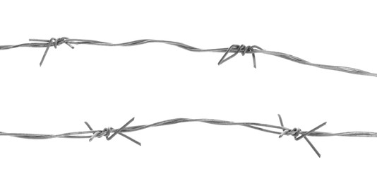 Photo of Shiny metal barbed wire isolated on white