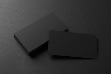 Photo of Blank business cards on black background, above view. Mockup for design