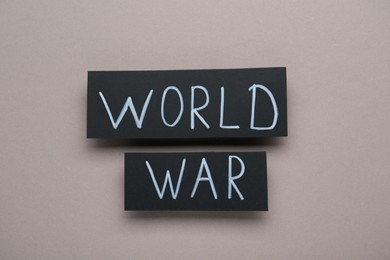 Photo of Cards with words World War on grey background, top view