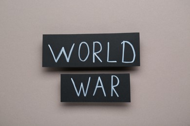 Cards with words World War on grey background, top view