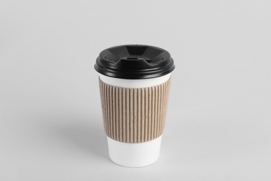 Photo of Paper cup with plastic lid on light background. Coffee to go