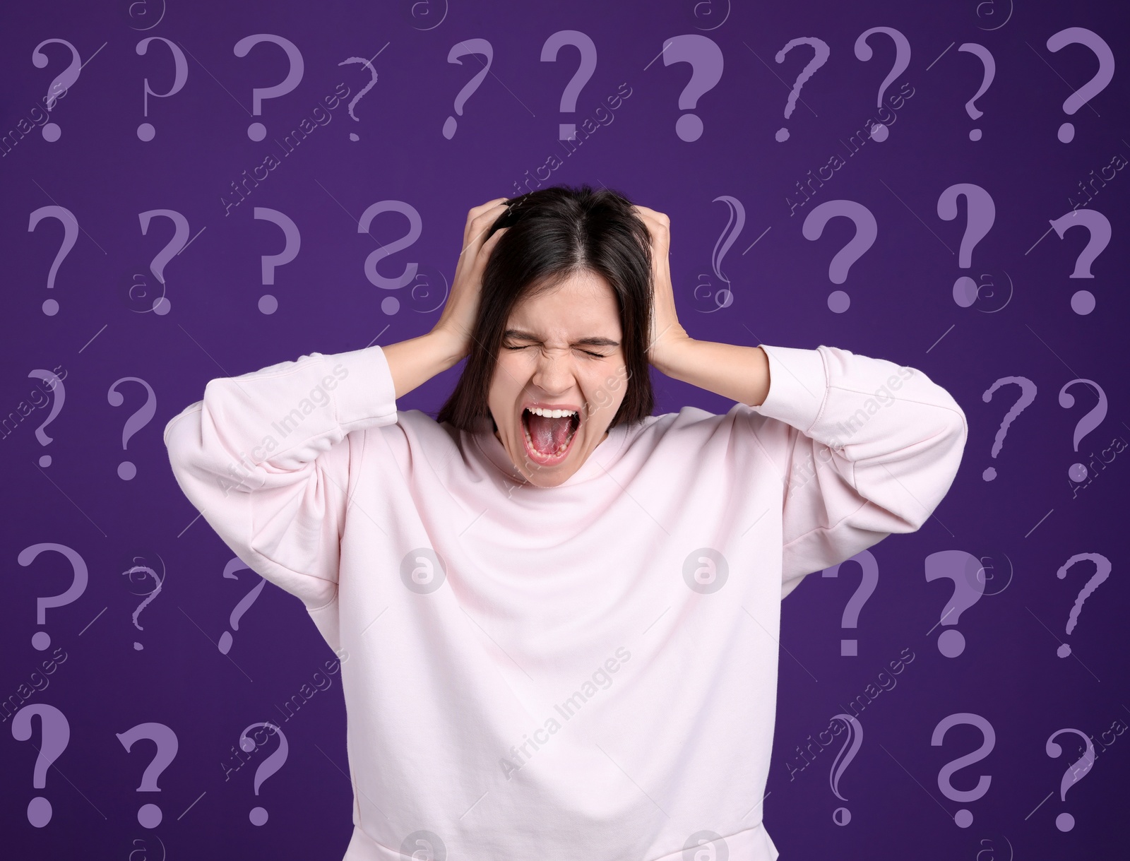 Image of Amnesia. Stressed young woman and question marks on purple background