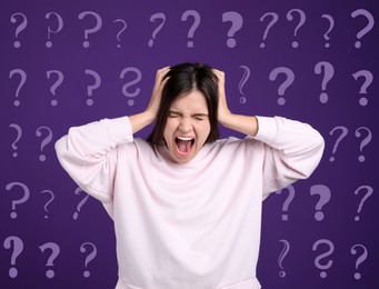 Image of Amnesia. Stressed young woman and question marks on purple background