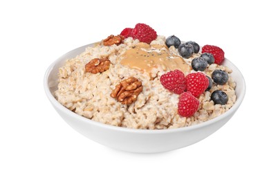 Photo of Tasty boiled oatmeal with berries, walnuts, peanut butter and chia seeds in bowl isolated on white